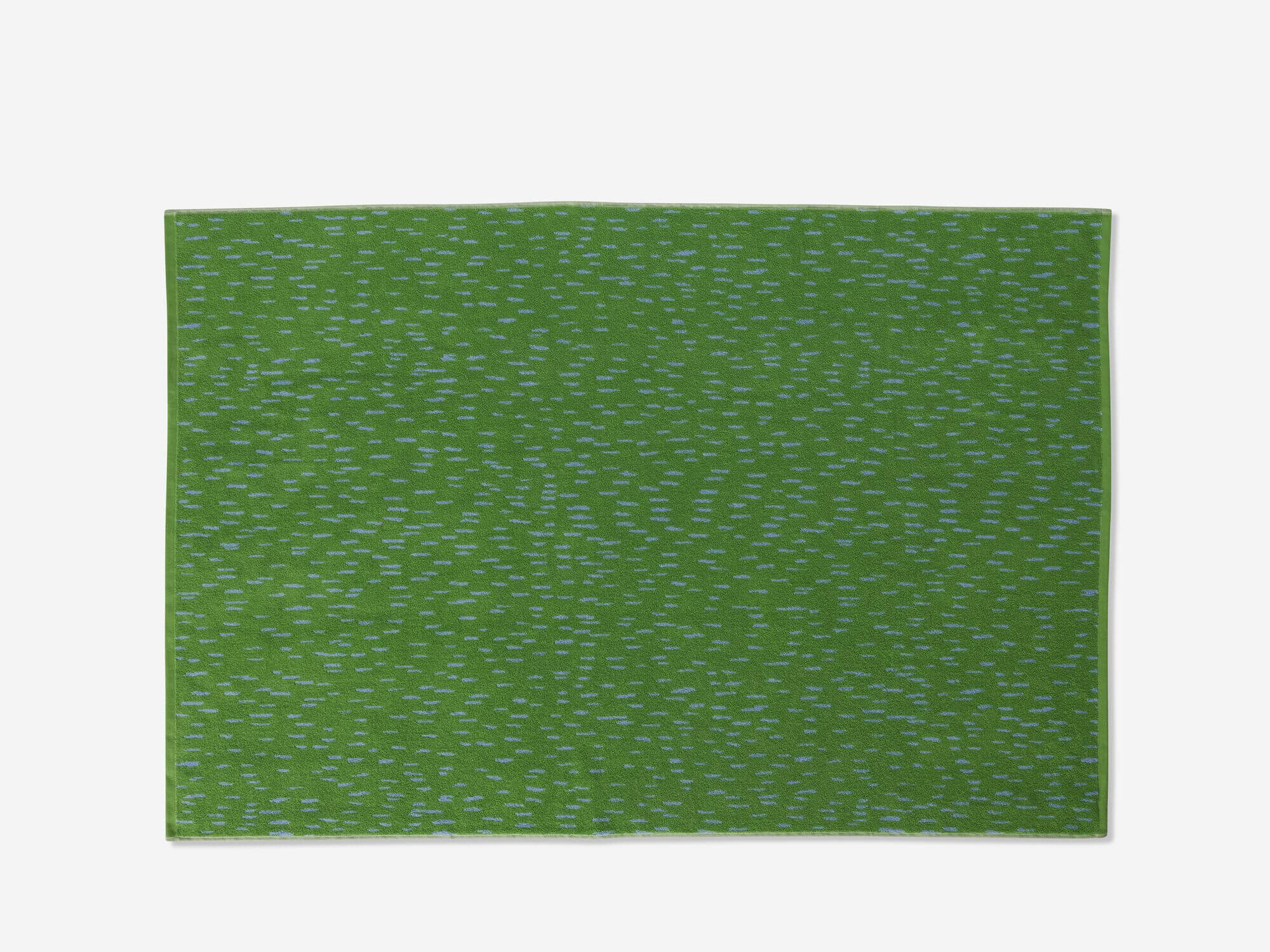 Top view of green spotted bath towel